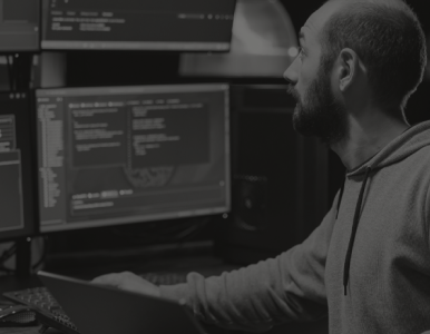 Man in front of computer screens